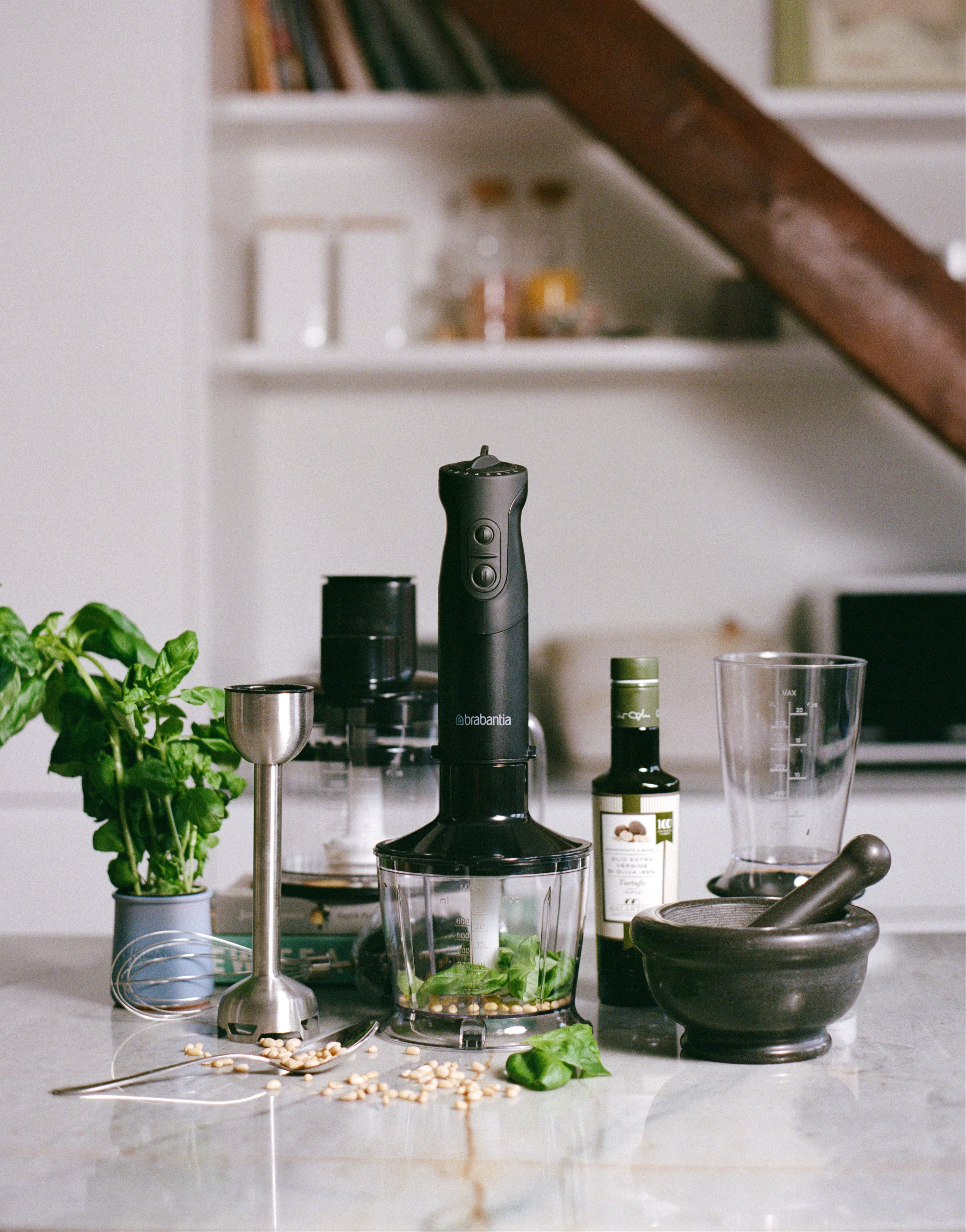Kitchen counter with blender, mortar and other accessories.